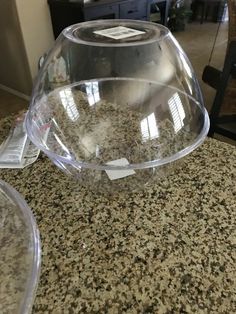 two clear bowls sitting on top of a counter