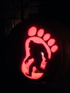 a carved pumpkin with an image of a bear and paw print on it's side