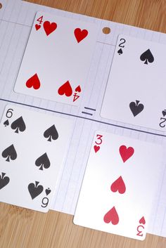 four playing cards are laid out on the table