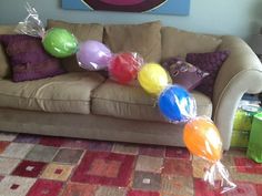 the balloons are on the couch in the living room, ready to be put into the air