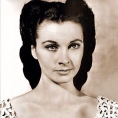 an old black and white photo of a woman with her hair in a high bun