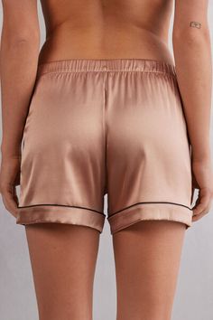 Light stretch silk satin shorts trimmed with elegant piping at the hem that is either tone-on-tone or in a contrasting color, depending on the color selected. Satin Bottoms For Loungewear, Satin Shorts For Loungewear, Satin Short Bottoms For Loungewear, Satin Loungewear Bottoms Short Length, Satin Lounge Shorts, Satin Loungewear Shorts, Feminine Satin Bottoms For Summer, Stretch Satin Bottoms For Summer, Satin Bottoms For Summer Loungewear