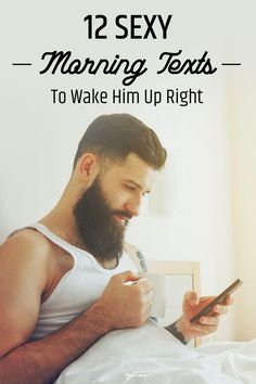 a man with a beard is texting on his cell phone while laying in bed