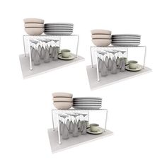 three shelves with plates and cups stacked on top of each other in front of a white background