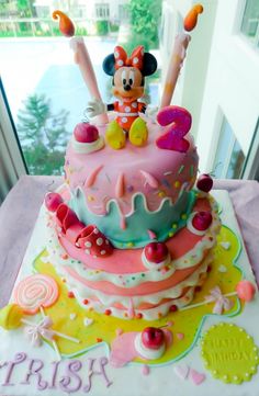 a birthday cake with minnie mouse on top