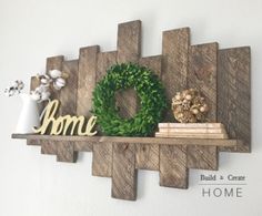 a wooden shelf with a wreath and some books on it