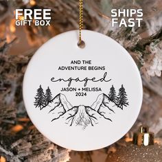 an ornament hanging from a christmas tree that says and the adventure begins engaged