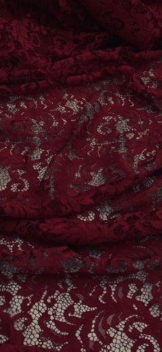 a red lace fabric with white flowers on it