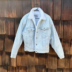 Vintage Levi's Authentic Faux Sheep Wool lined jean jacket. Light pale blue denim. Size small. Red tag. Classic ninties look. The shoulders on the jean jacket in the back show some light yellowing. The piece is in otherwise good vintage condition. Measures laying flat: under arm to under arm  23.5" x top of shoulder to bottom or wrist 22.5" x wasit band 19". Shipping is included in the price. (Shipping may be listed as free- but of course its not really free...) We believe in transparency and honesty even in marketing and want you to know we are just including shipping in your purchase price.  We use USPS ground mail when ever possible. If you need an International quote or faster shipping send over a message with details and we will get you a quote. We love being able to save you so if yo Winter Light Wash Relaxed Fit Denim Jacket, Winter Outerwear In Light Wash With Relaxed Fit, White Jeans With Pockets For Winter, Light Wash Winter Denim Jacket, Fitted Medium Wash Denim Jacket For Winter, Winter Jeans In Denim Blue With Button Closure, Winter Light Wash Denim Jacket, Light Wash Denim Jacket For Winter, Winter Button Closure Denim Jeans