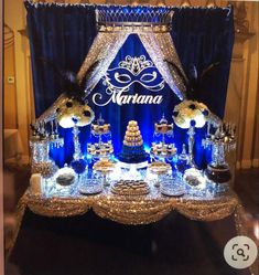 a blue and white dessert table with an elaborate sign on the top that says marinana