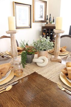 a dining room table is set with place settings