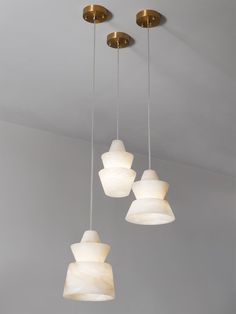 three lights hanging from the ceiling in a room