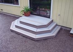 a set of steps sitting next to a building with a potted plant on top