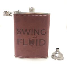 a brown leather flask with the words swing fluid printed on it