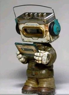 an old fashioned robot with headphones on holding a cell phone