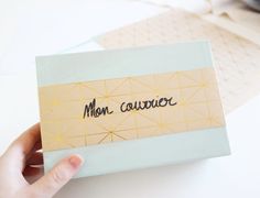 a person holding up a piece of paper with the word mon caurivor written on it