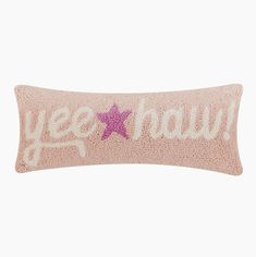 a pink pillow with the words yeee haw on it