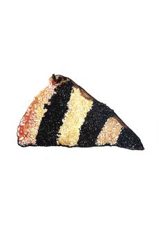 a piece of black, yellow and red food on a white background