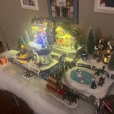 a christmas village is displayed on a table