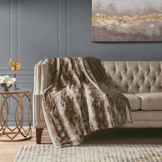 a living room with a couch, table and rug