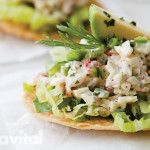 an open pita sandwich with lettuce and chicken salad on it, ready to be eaten