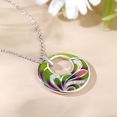 Add a pop of color to your look with the flower enamel necklace. An unusual silver necklace finished with a pendant of mixed coloured enamel circle set in a flower design. A tonal combination of colours make this a very versatile necklace to wear with lots of different outfits.Carat Weight: 0.225 ctStone Size: 1,1.2 mmNumber of Stones: 17 Stone Shape: RoundStone Color: Diamond WhiteWeight: 4.93 gWidth: 25 mmHeight: 28.8 mmThickness: 5.3 mmMaterial: 925 SilverStone Type: Jeulia® StonePlating Colo Enamel Round Pendant Necklace, Multicolor Enamel Round Pendant Necklace, Multicolor Enamel Pendant Necklaces, Multicolor Enamel Pendant Necklace, White Gold Enamel Round Pendant Necklace, White Gold Enamel Necklaces, Green Enamel Round Pendant Jewelry, Dreamy Garden, Enamel Necklaces