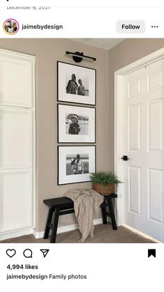 three framed pictures hang on the wall next to a black stool and two white doors