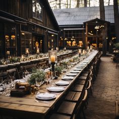 a long table is set with place settings and candles