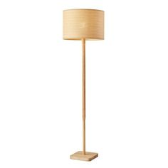 a wooden floor lamp with a beige shade on it's side and a white background