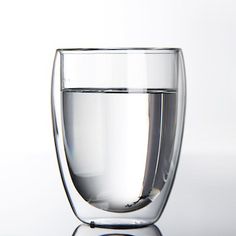 a glass filled with water sitting on top of a table