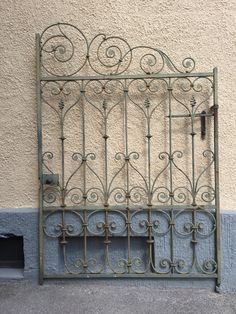 an iron gate on the side of a building