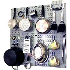 a peg board with pots and pans on it