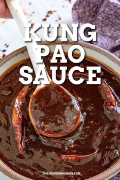 a hand holding a spoon in a bowl filled with sauce and the words kunng pao sauce above it