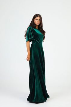 a woman wearing a green velvet dress