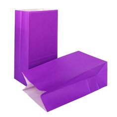 purple paper bags are stacked on top of each other