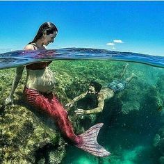 a man and woman are swimming in the ocean