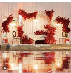 a room decorated with red flowers and chairs