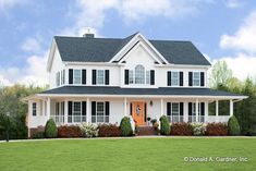 a large white house with black shutters on the front