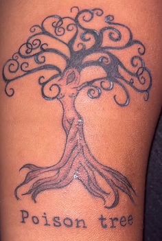 a woman's leg with a tree tattoo on it and the words poison tree