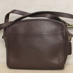 This lovely brown Coach crossbody bag measures approximately 7” x 9” x 3”. It is a used bag with minimal wear with a split seem on the interior. Please closely inspect all photos before purchasing. Closure: Zip Strap Drop: 15” Color: Brown Pockets: 1 Interior & 1 Exterior Material: Leather Style: Crossbody Bag Photos are Actual pictures, not stock photos. Authenticity Note: We have been trained to spot fake designer bags, and closely inspect each purse to verify authenticity. If we have any doub Formal Vintage Brown Crossbody Bag, Vintage Brown Crossbody Bag For Formal Occasions, Coach Brown Soft Leather Shoulder Bag, Formal Brown Coach Shoulder Bag, Vintage Brown Coach Shoulder Bag, Coach Leather-lined Crossbody Bag, Coach Brown Satchel In Soft Leather, Coach Leather Crossbody Bag, Coach Brown Shoulder Bag Satchel