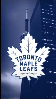 the toronto maple leafs sign is in front of a tall building with a sky background