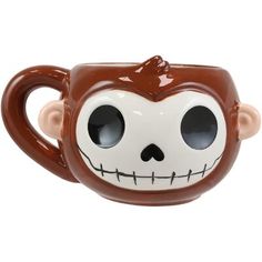 a brown and white monkey shaped mug with eyes on it's face, sitting in front of a white background