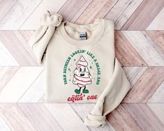 This funny Little Debbie Christmas tree cake sweatshirt is sure to be your new favorite! Such a classic and perfect to wear all season long. Our designs are printed on Gildan 18000 sweatshirts. Ideal for any situation, a unisex heavy blend crewneck sweatshirt is pure comfort, with a loose fit and medium-heavy fabric. Please note the unisex sizing. It's important to check the included size chart to compare with a favorite tee already in your possession. Sweatshirts are made in the USA. Fiber comp Papa Shirts, Balls Shirt, Shamrock Shirt, Retro Sweatshirts, Winter Shirts, Funny Christmas Shirts, Sweatshirt Christmas, Holiday Sweater, Retro Halloween