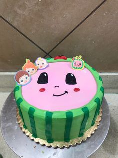 a birthday cake decorated with the face of a watermelon