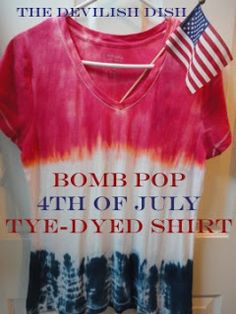 a tie - dyed shirt with the words bomb pop, 4th of july, tied to a hanger