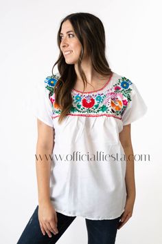 Mexican Embroidered Pueblo Blouse - White  These fabulous blouses feature a unique colorful embroidered pattern. These embroidered blouses are also commonly known as Mexican Peasant Blouse Tops.  Please note that each blouse is individually hand embroidered so the embroidery design will vary from the one pictured. You will receive the blouse color selected. White Embroidered Hem Blouse For Festival, White Embroidered Folk Peasant Top, Folk Style White Blouse With Embroidered Hem, White Peasant Top With Embroidered Hem, White Folk Blouse With Embroidered Hem, White Peasant Tops With Geometric Embroidery, White Peasant Top With Embroidered Border, White Short Sleeve Blouse With Embroidered Sleeves, White Blouse With Embroidered Short Sleeves