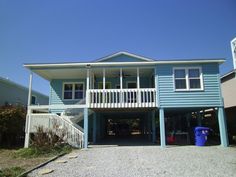 a blue two story house with white balconies