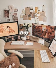 a desk with two computer monitors and a teddy bear