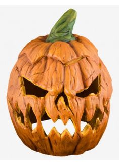 a carved pumpkin with an evil face on it's front and side, is shown