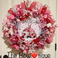 a valentine's day wreath on the front door with an image of a cat